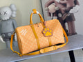 Louis Vuitton monogram duffel bag with yellow trim and paw logo charm