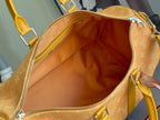Louis Vuitton monogram bag interior with open zipper and tan lining