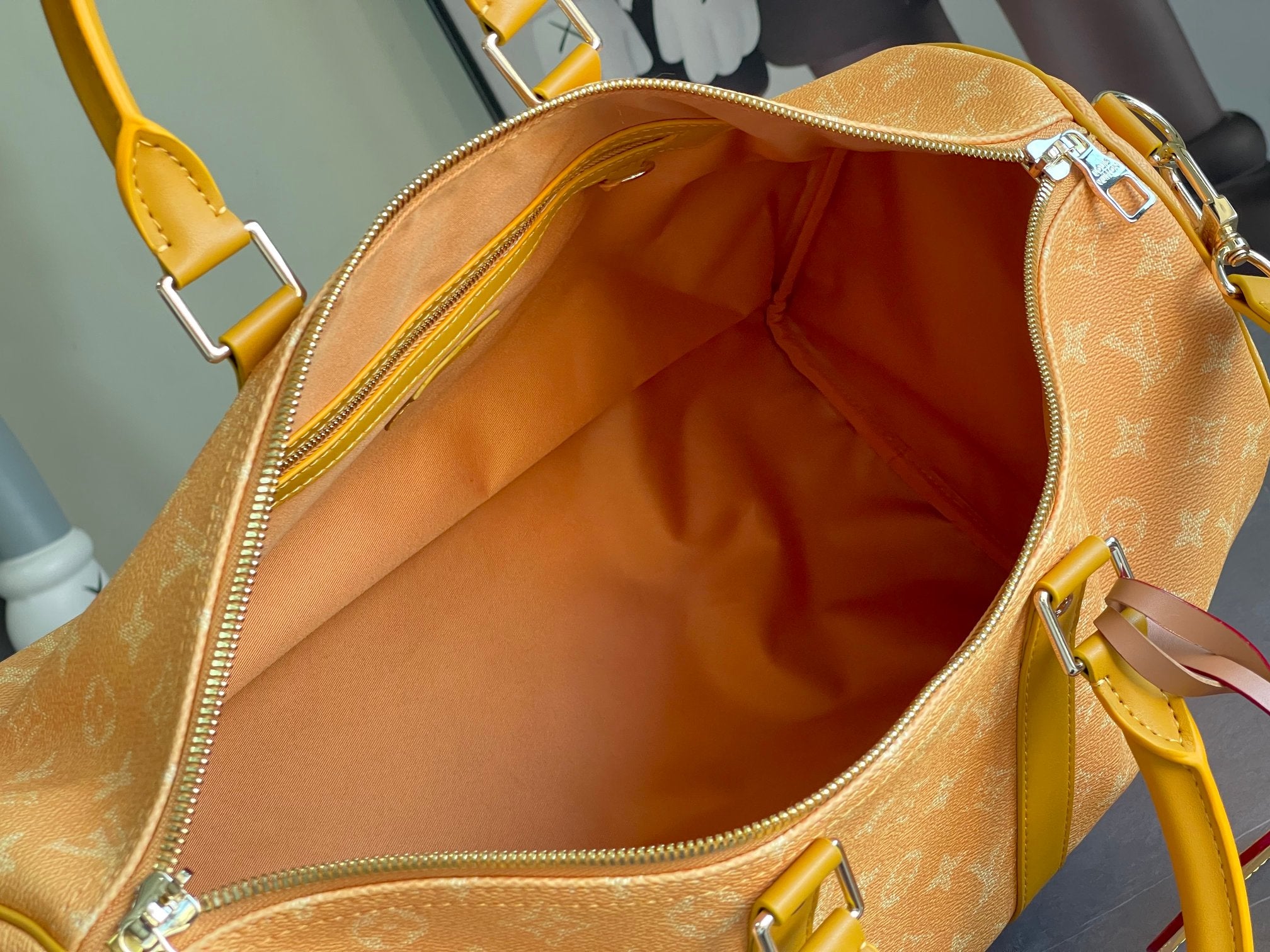 Louis Vuitton monogram bag interior with open zipper and tan lining