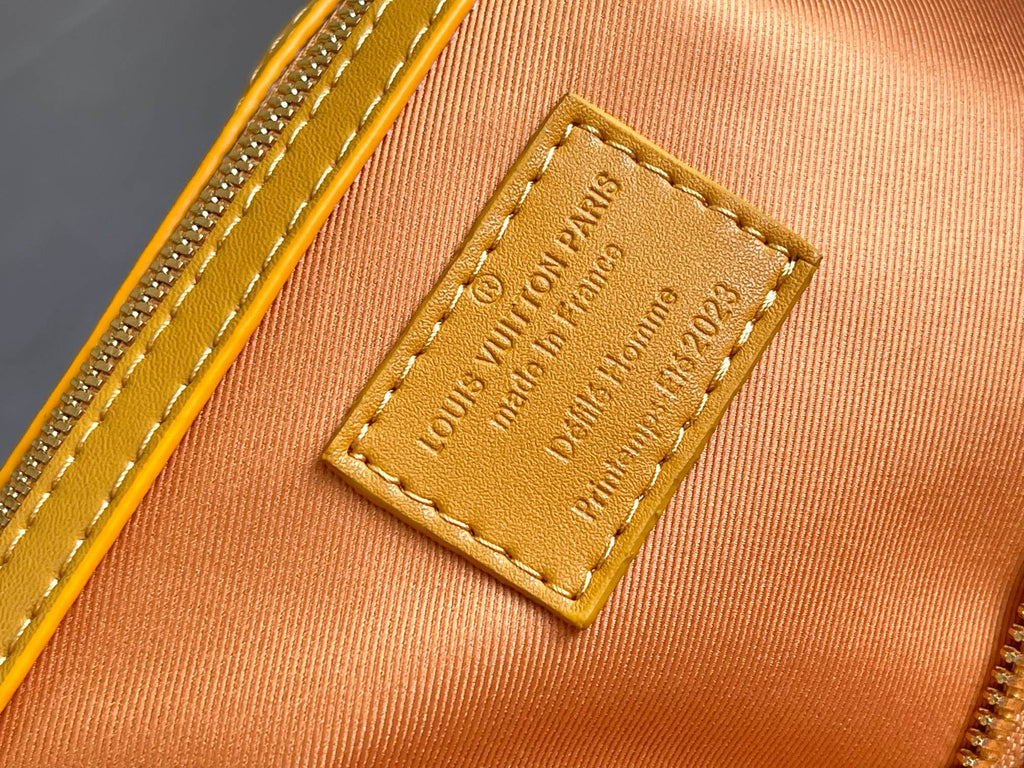 Louis Vuitton Paris leather tag with embossed text on monogram bag