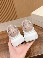 Pair of white low-top sneakers with beige heel lining and branded back tabs.