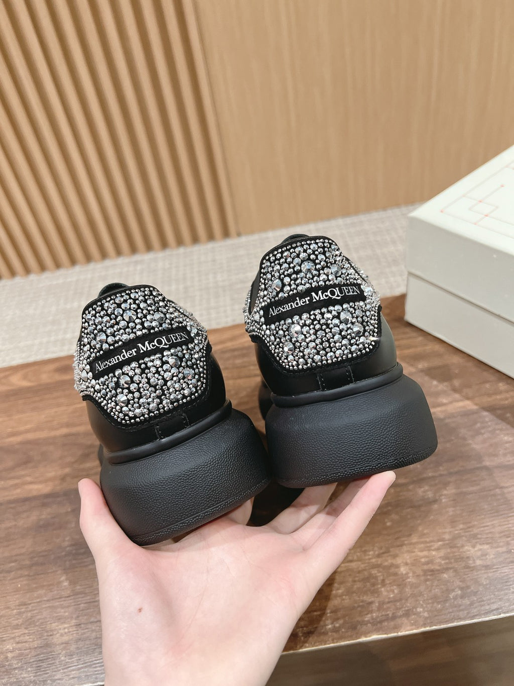 Black sneakers with rhinestone heel panels and Alexander McQueen logo on back