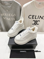 White lace-up sneakers with fluffy collar lining and Chanel logo, thick platform sole pair