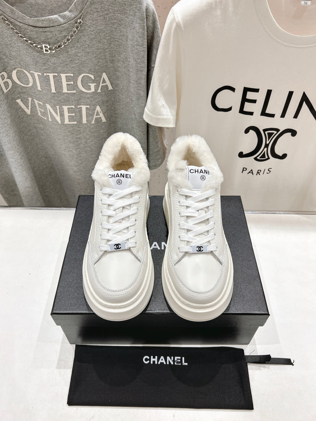 White lace-up sneakers with faux-fur collar, Chanel logo patch, thick sole pair