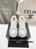 White lace-up sneakers with faux-fur collar, Chanel logo patch, thick sole pair