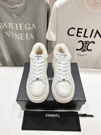 White lace-up sneakers with faux-fur collar, Chanel logo patch, thick sole pair