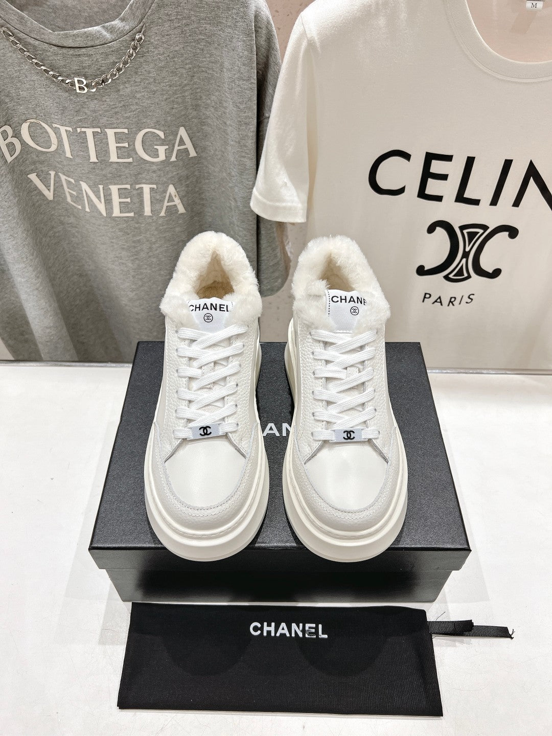White lace-up sneakers with faux-fur collar, Chanel logo patch, thick sole pair