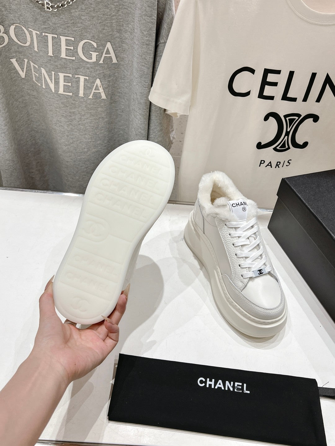 White sneaker outsole and lace-up shoe with faux-fur collar, Chanel logo detail