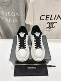 Low-top sneakers in white with black faux-fur collar and black lace-up front
