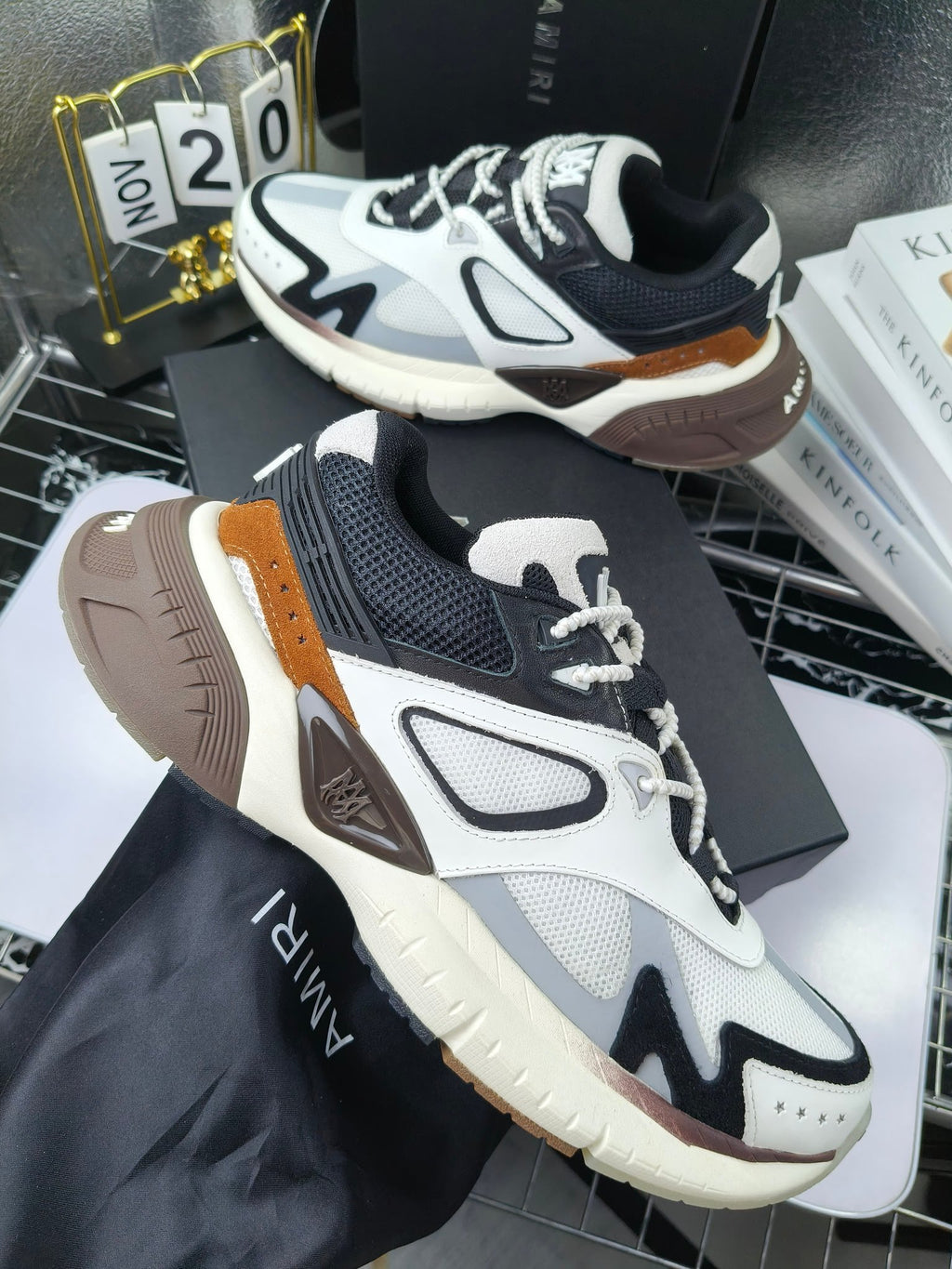 Amiri sneakers in white, navy, and brown with lace-up design