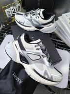 Amiri sneakers in white with black panels and lace-up top