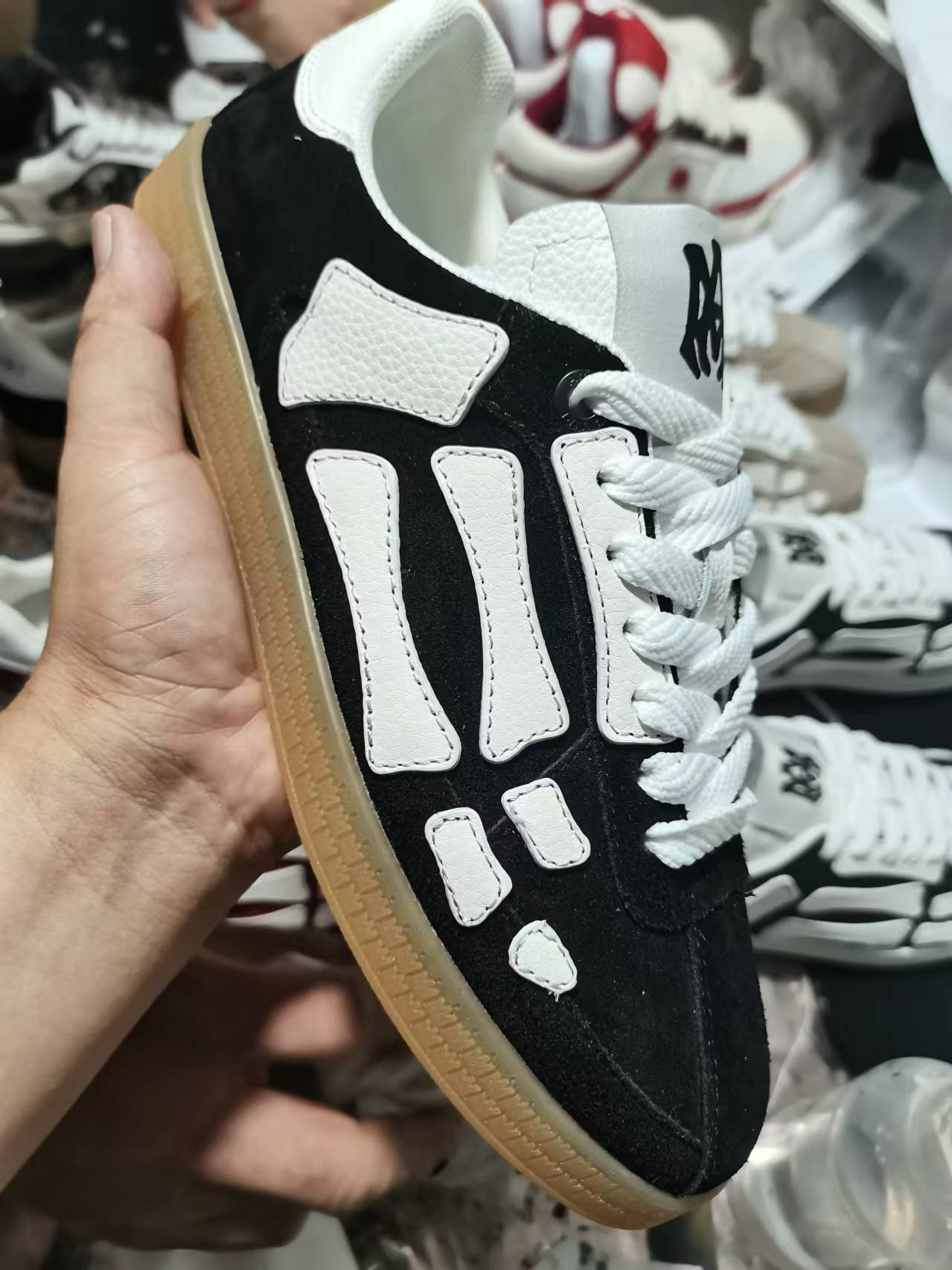 Amiri low-top sneakers, black suede with white side panels and gum sole