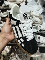 Amiri low-top sneakers, black suede with white panels, white laces and gum sole