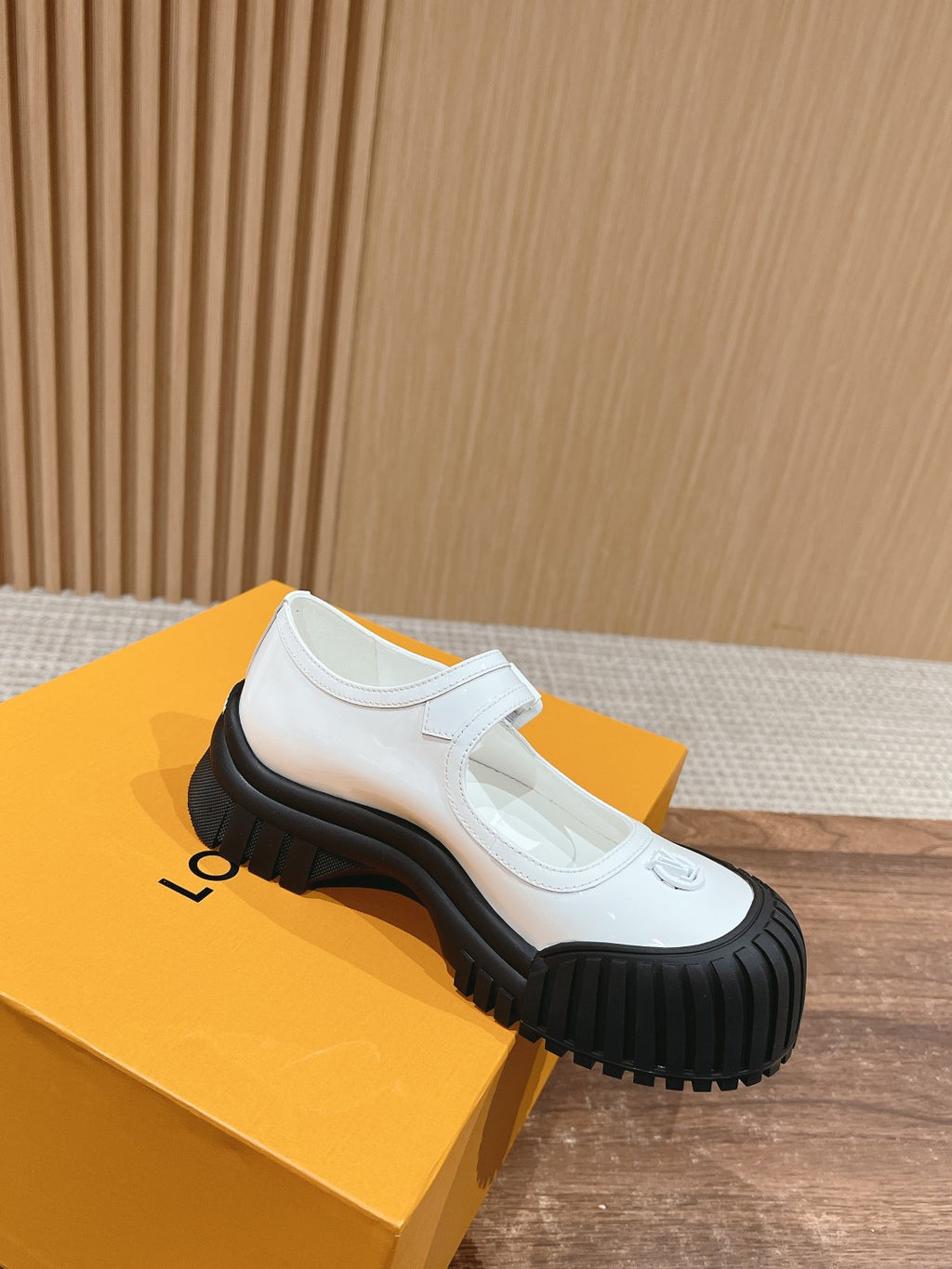 White leather slip-on sneaker with Velcro strap and black rubber outsole