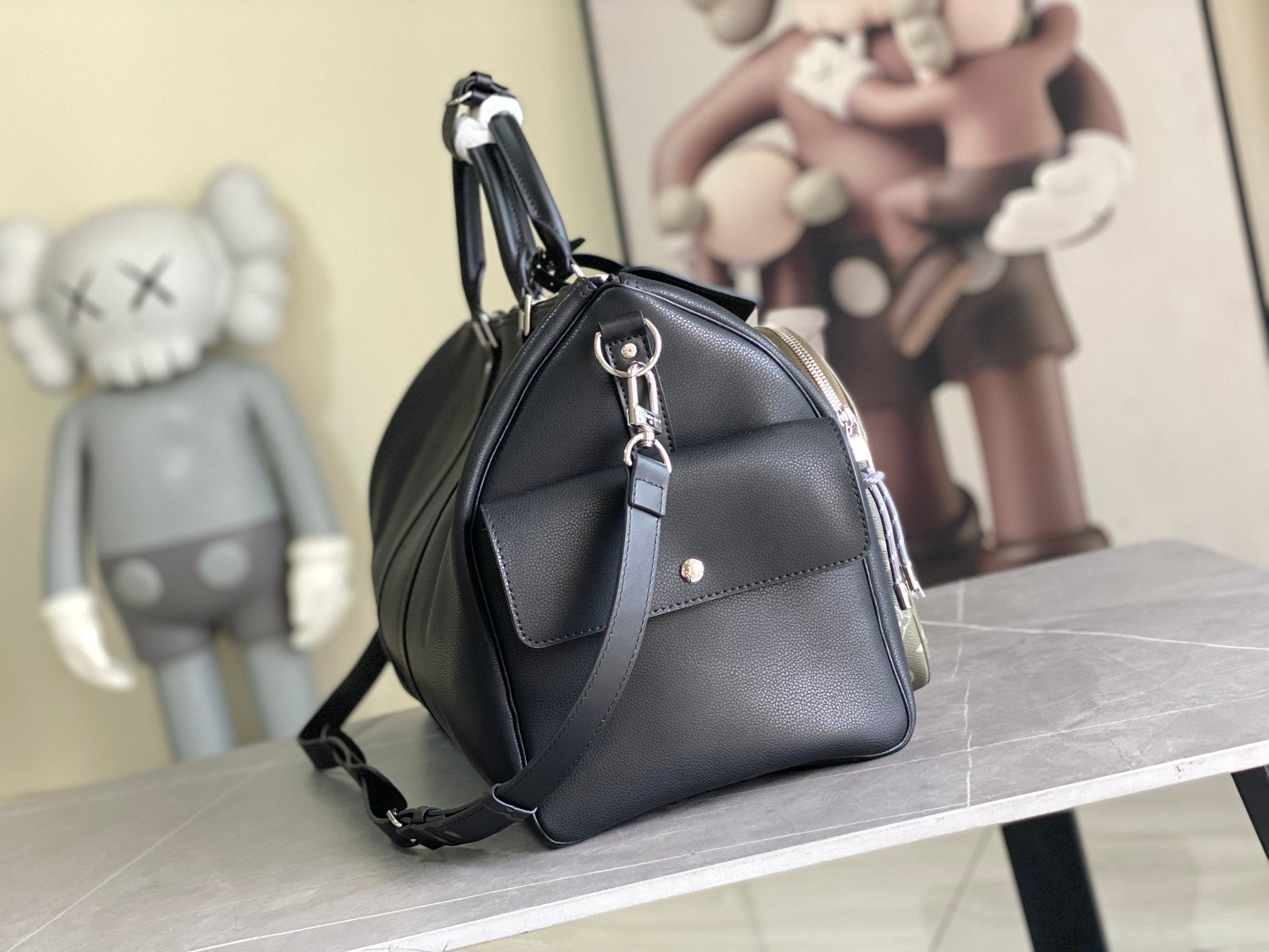 Louis Vuitton men’s leather duffle bag with front flap detail, rings, and shoulder strap