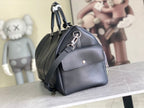 Louis Vuitton handbag in dark blue leather with top handle and front flap hardware.
