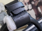 Louis Vuitton men’s leather bag with stamped branding and textured strap detail