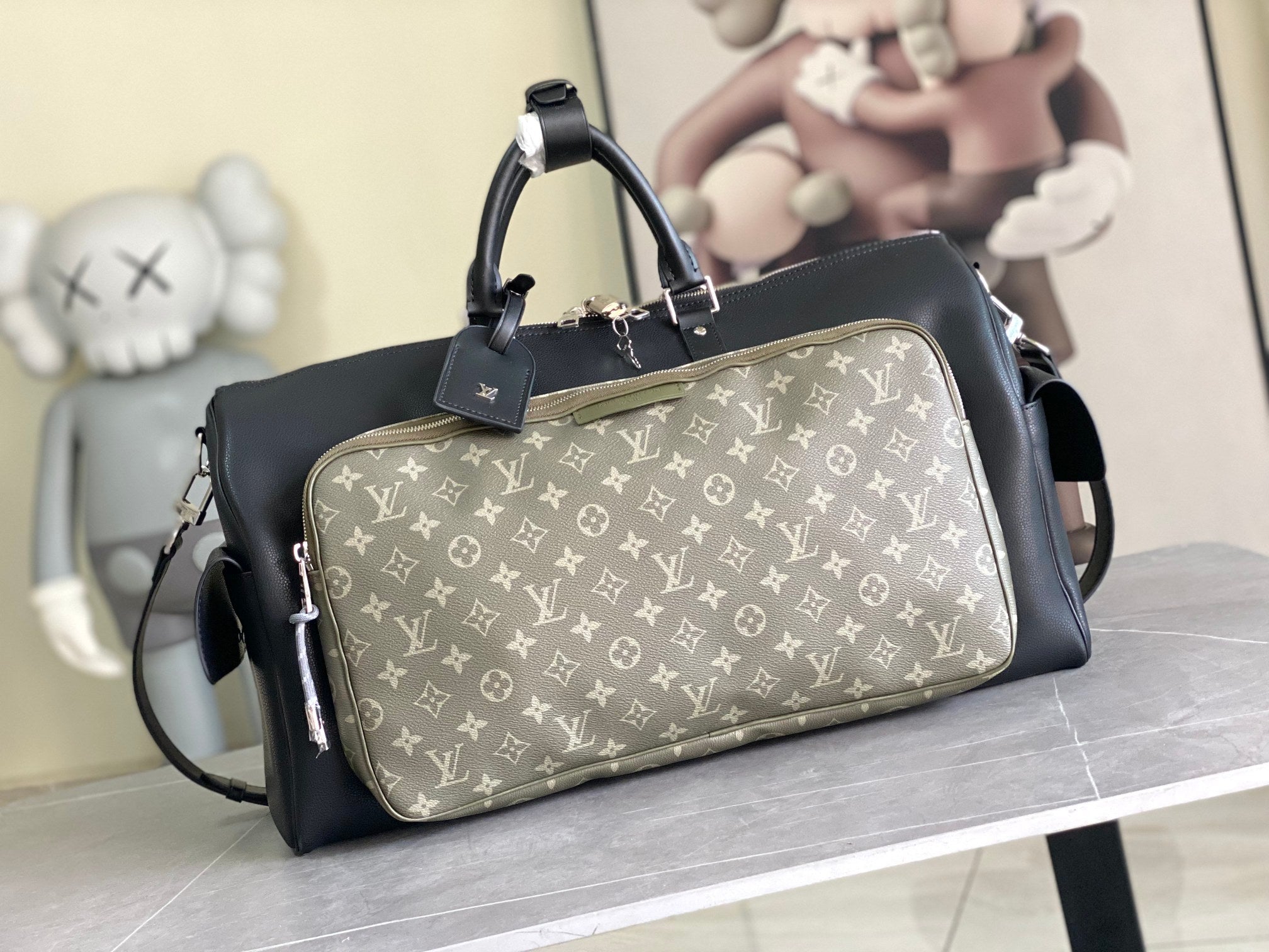 Louis Vuitton men’s duffle bag with dark body and light monogram canvas front panel