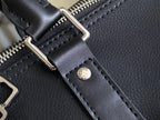 Louis Vuitton leather strap detail with gold-tone buckle and stitched edges.