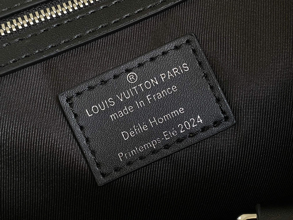 Louis Vuitton bag leather interior label, dark fabric with text