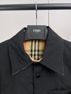 Quilted jacket with stand collar, dark outer and plaid lining at neckline