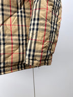 Plaid puffer jacket sleeve with elastic cuff and quilted seams
