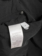 Black long jacket with quilted fabric and interior label tag