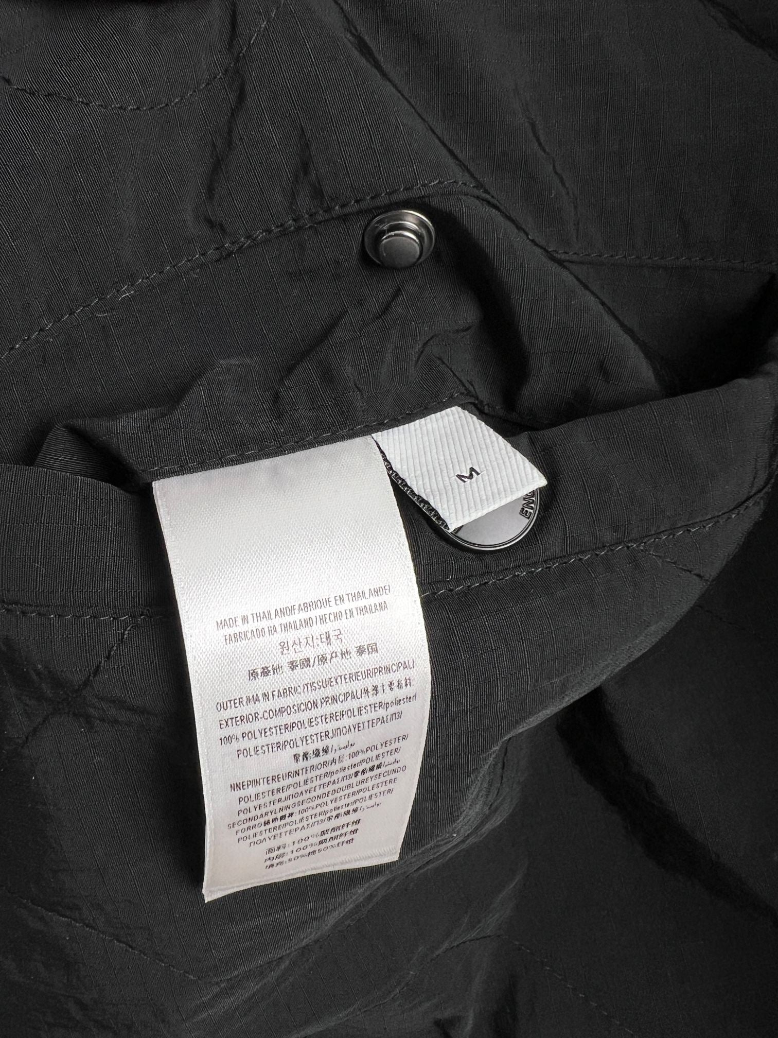 Black long jacket with quilted fabric and interior label tag