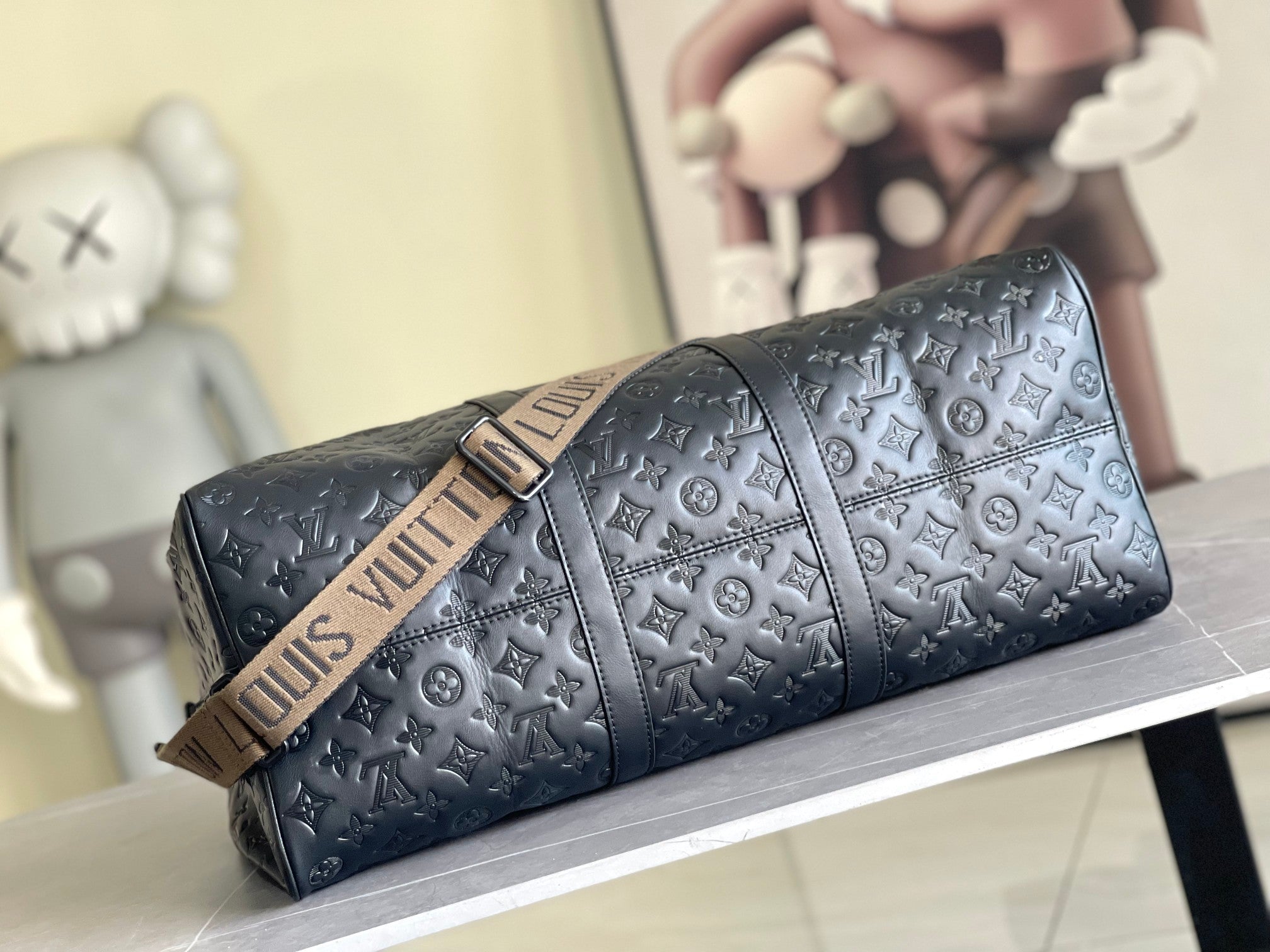 Men’s Louis Vuitton monogram duffel bag with embossed pattern, top handle, and luggage-style strap