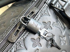 Louis Vuitton monogram duffel bag hardware detail with zipper track, metal clasp, and embossed leather
