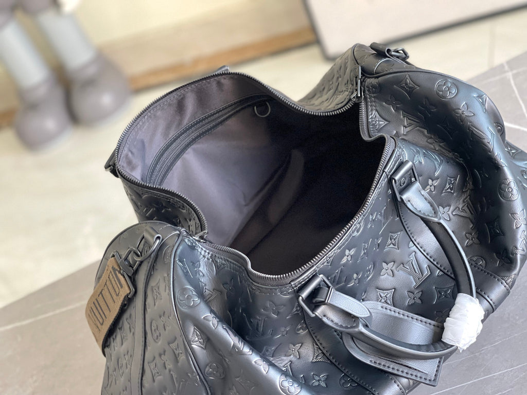 Louis Vuitton dark blue monogram duffel with open top and interior zip pocket