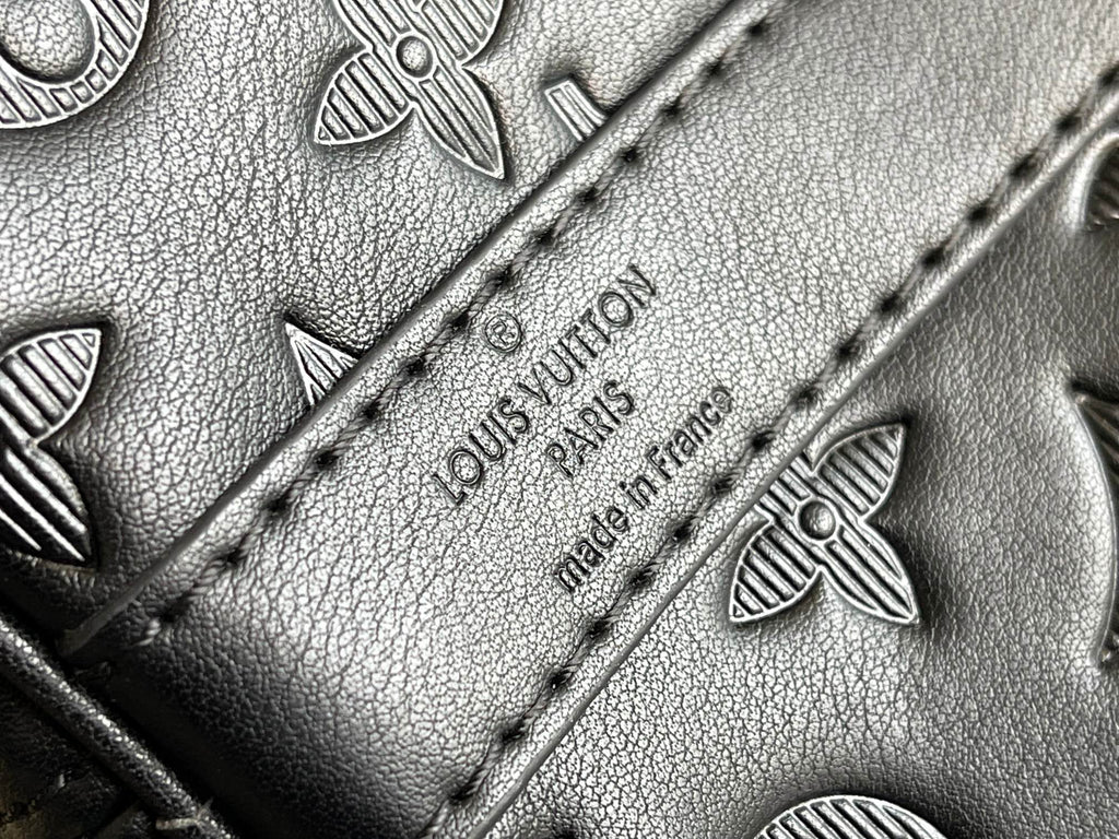 Louis Vuitton monogram leather close-up of stitched panel and embossed flowers