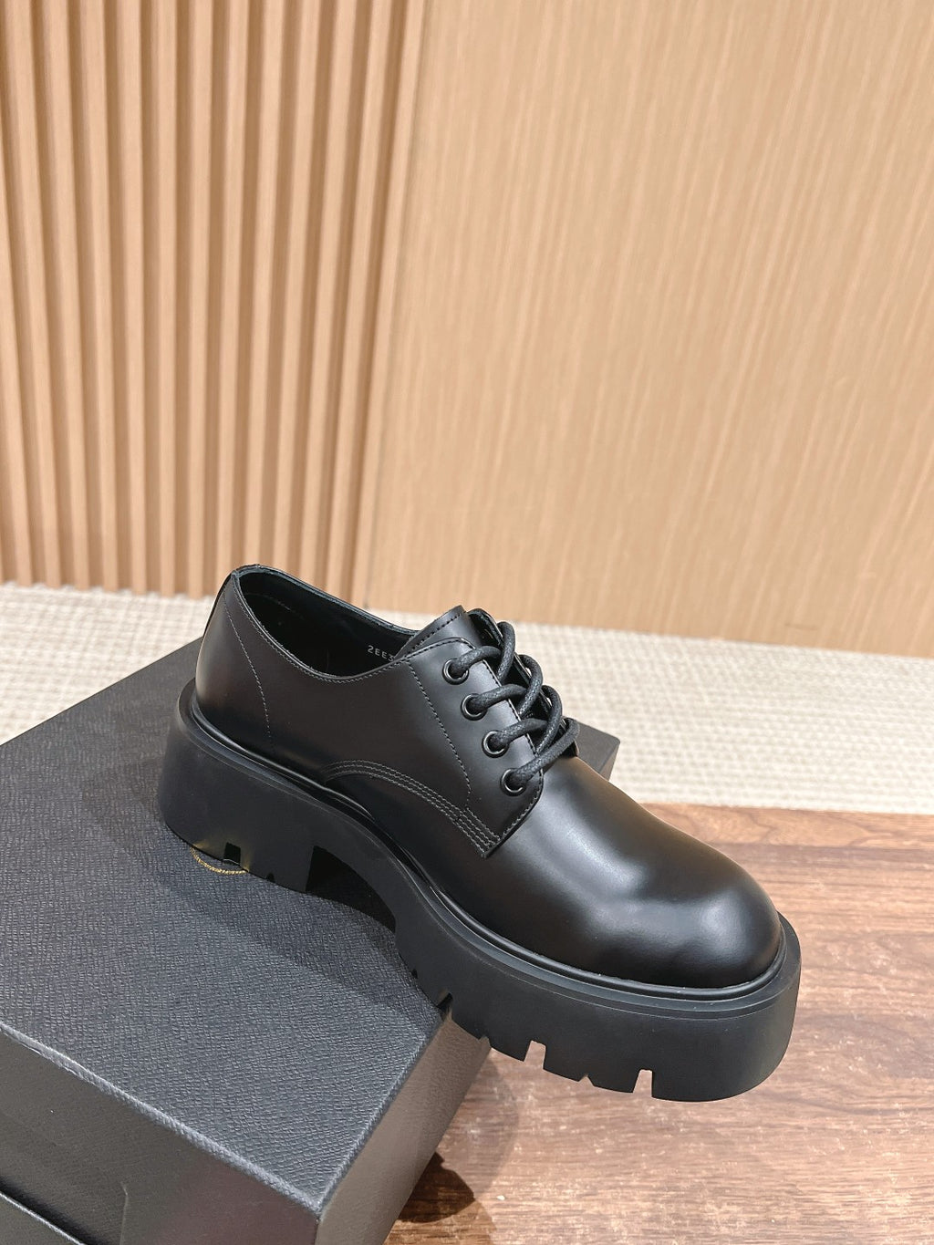Black lace-up leather shoe with rounded toe and chunky platform sole