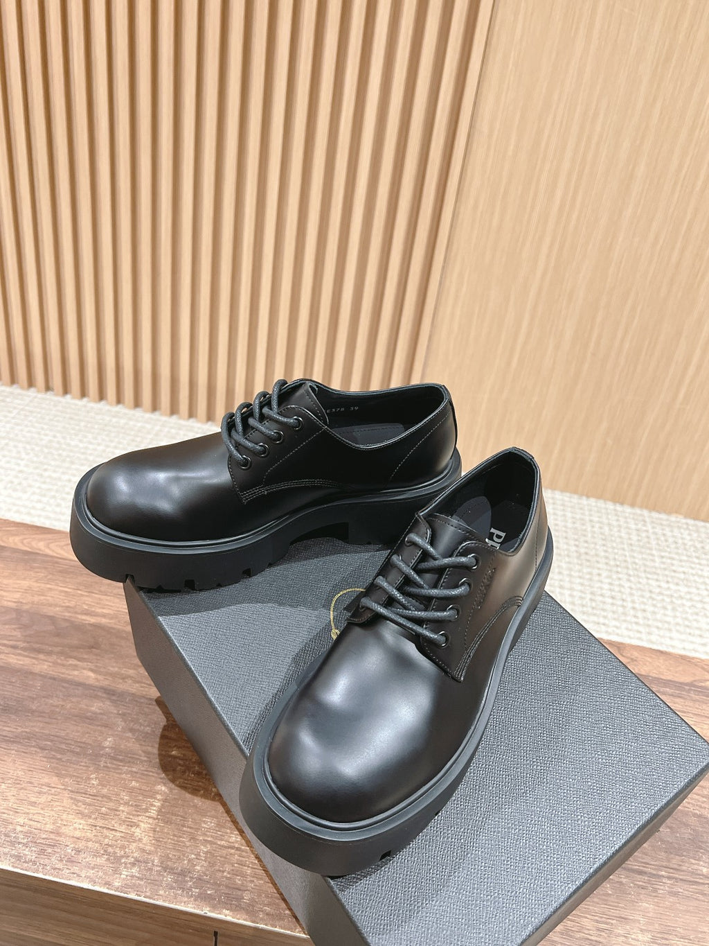 Black lace-up leather shoes with rounded toe and chunky platform sole