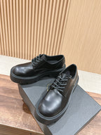 Black lace-up leather shoes with rounded toe and chunky platform sole