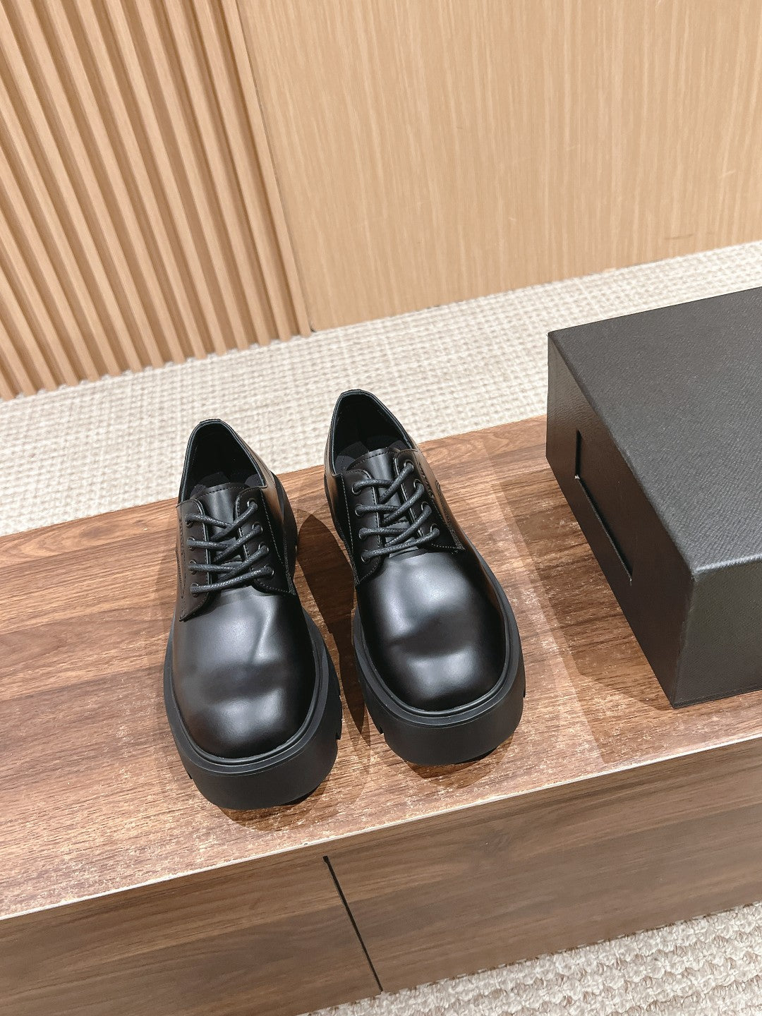 Black lace-up leather shoes with chunky rubber sole
