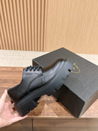 Black leather lace-up shoe with contrast stitching and sculpted sole