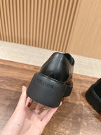 Black leather lace-up shoe heel with Prada logo stamp and chunky sole