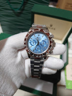 Rolex watch with blue dial, three chronograph subdials, and stainless steel bracelet