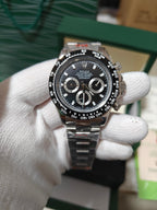 Rolex wrist watch with black dial and metal bracelet