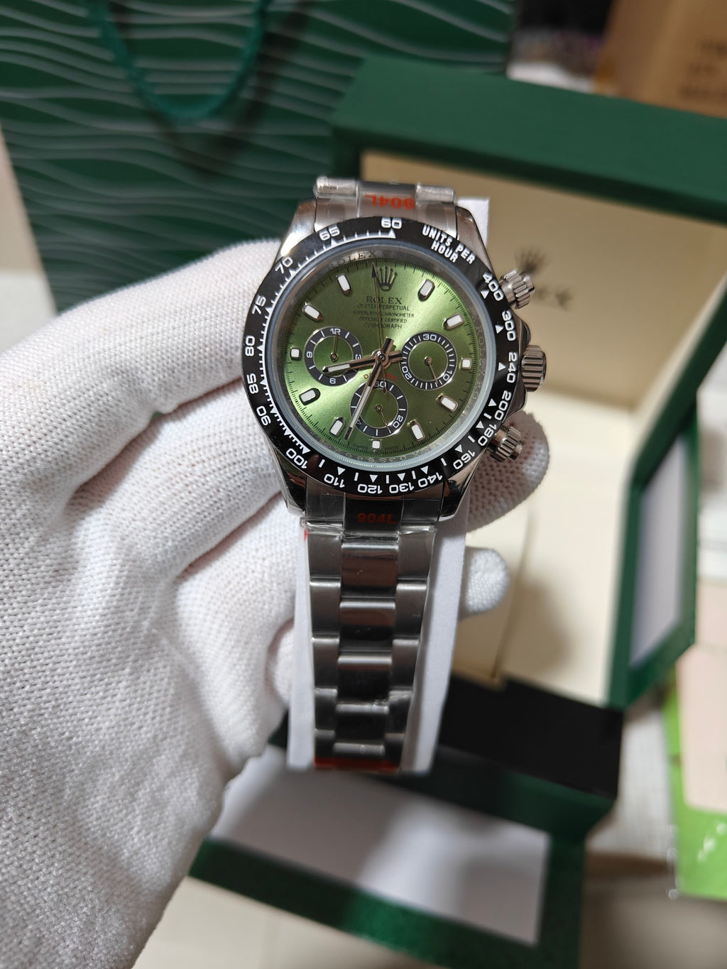 Rolex wrist watch with green dial and metal bracelet