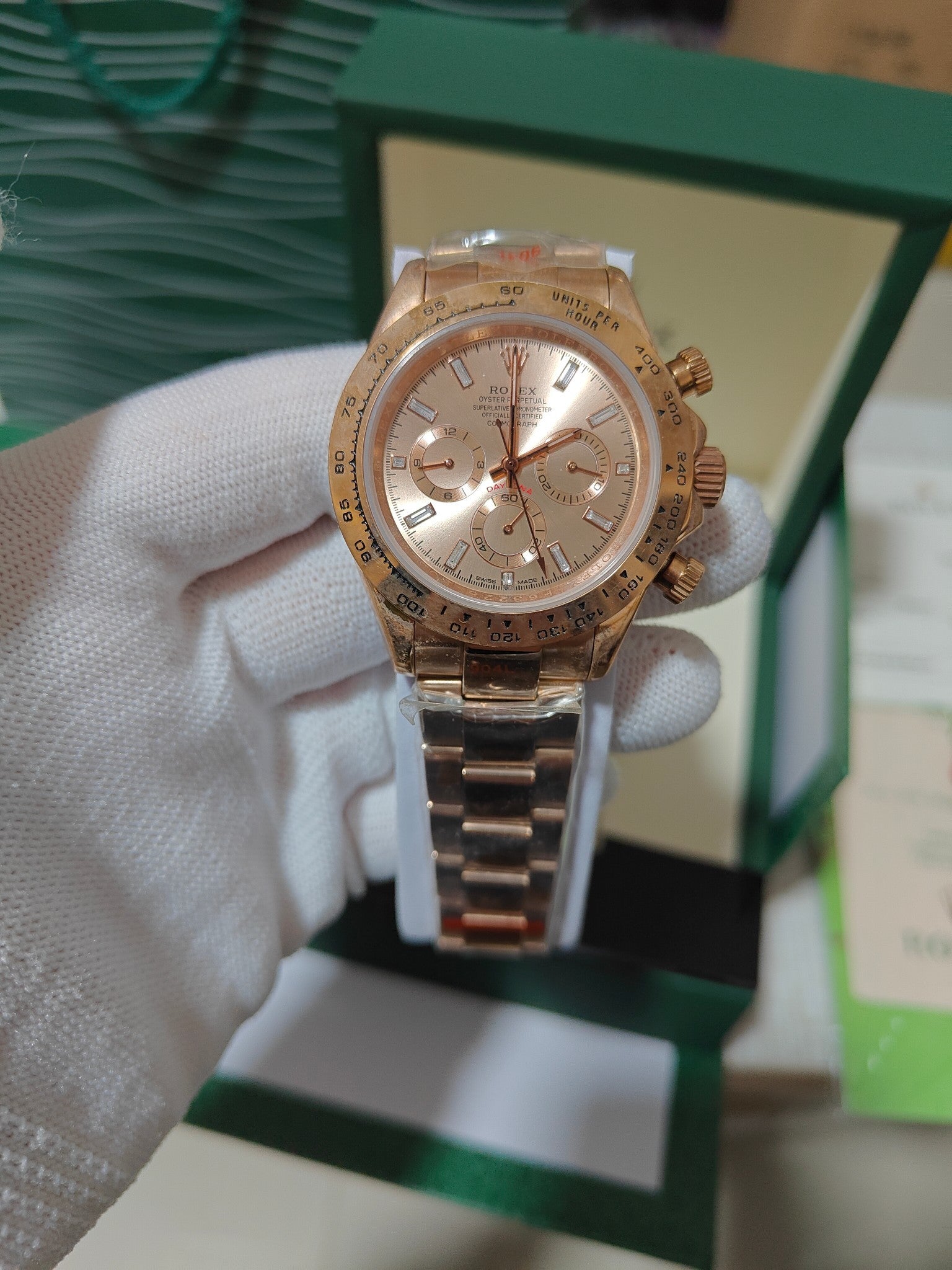 Rolex chronograph watch with gold-tone metal bracelet, rose-gold case, champagne dial and subdials