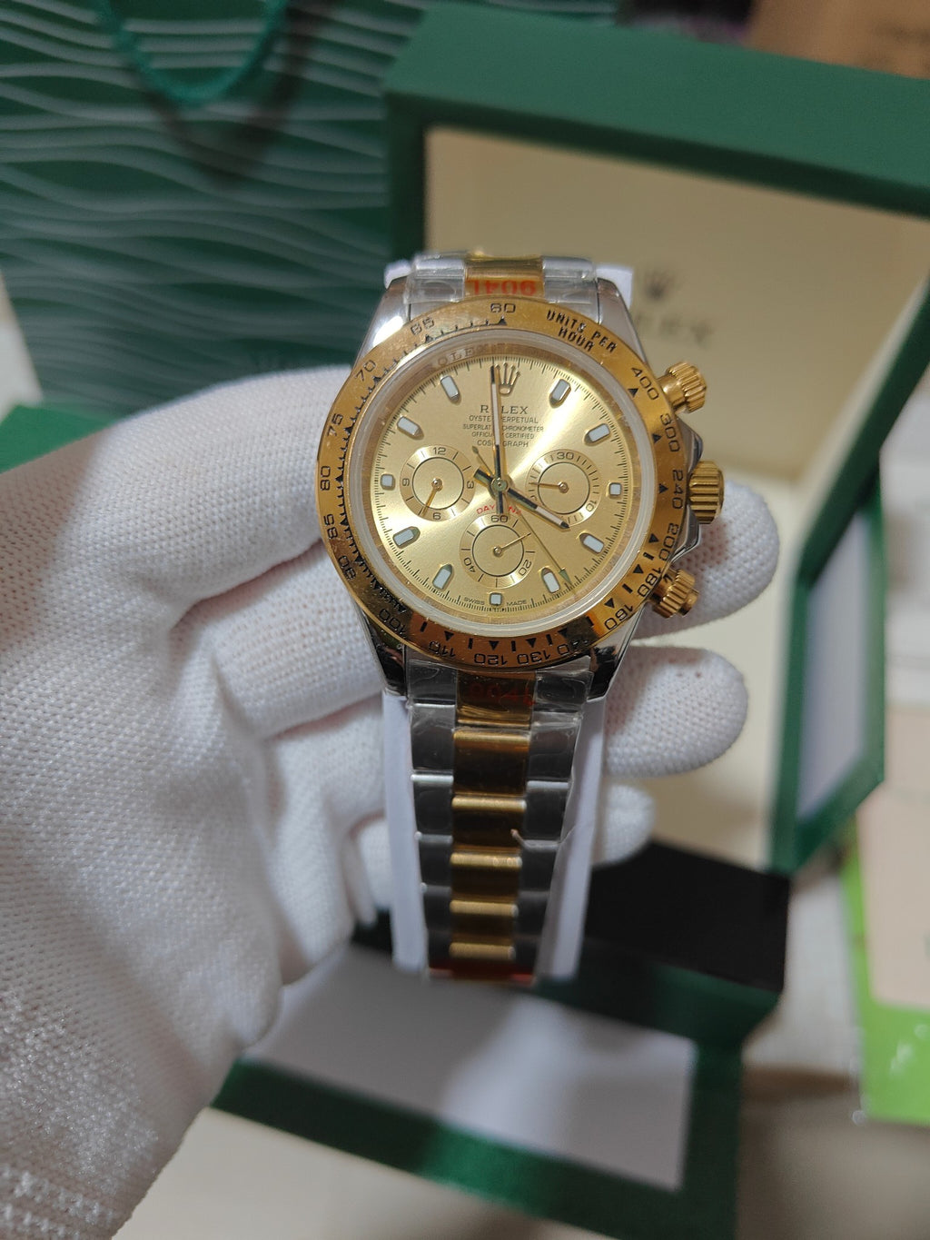Rolex watch with rose-gold tone case, champagne dial, and two-tone metal bracelet