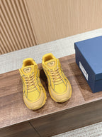 Yellow lace-up Dior unisex sneakers with logo tongue labels and textured sole
