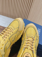 Close-up of yellow sneaker toe and side panel with woven texture
