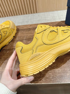 Yellow Dior unisex lace-up sneaker with rear logo patch and ribbed sole