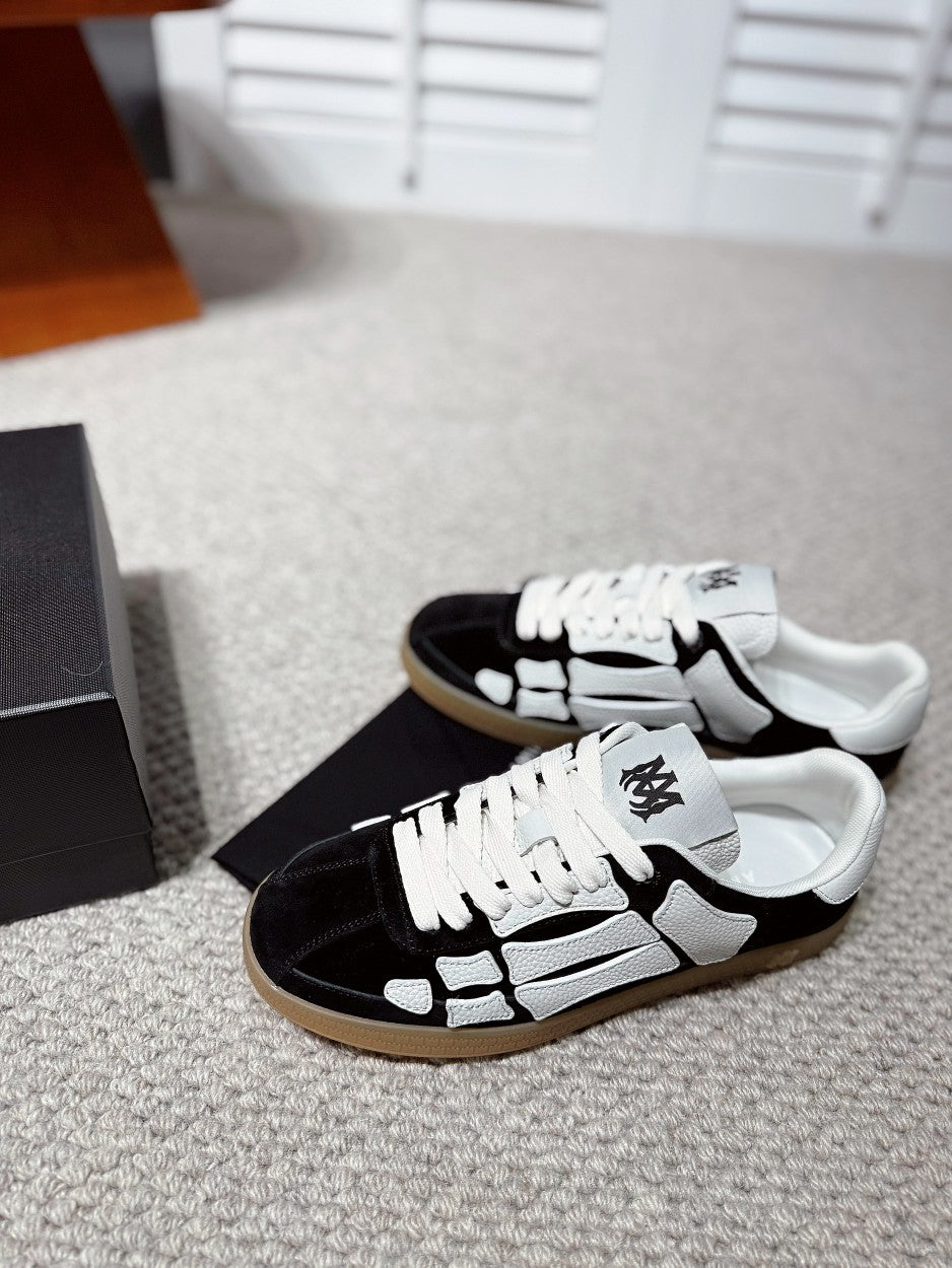 Black-and-white low-top sneaker pair, white laces and gum sole
