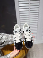 White low-top sneaker with black suede overlays, lace-up, gum sole