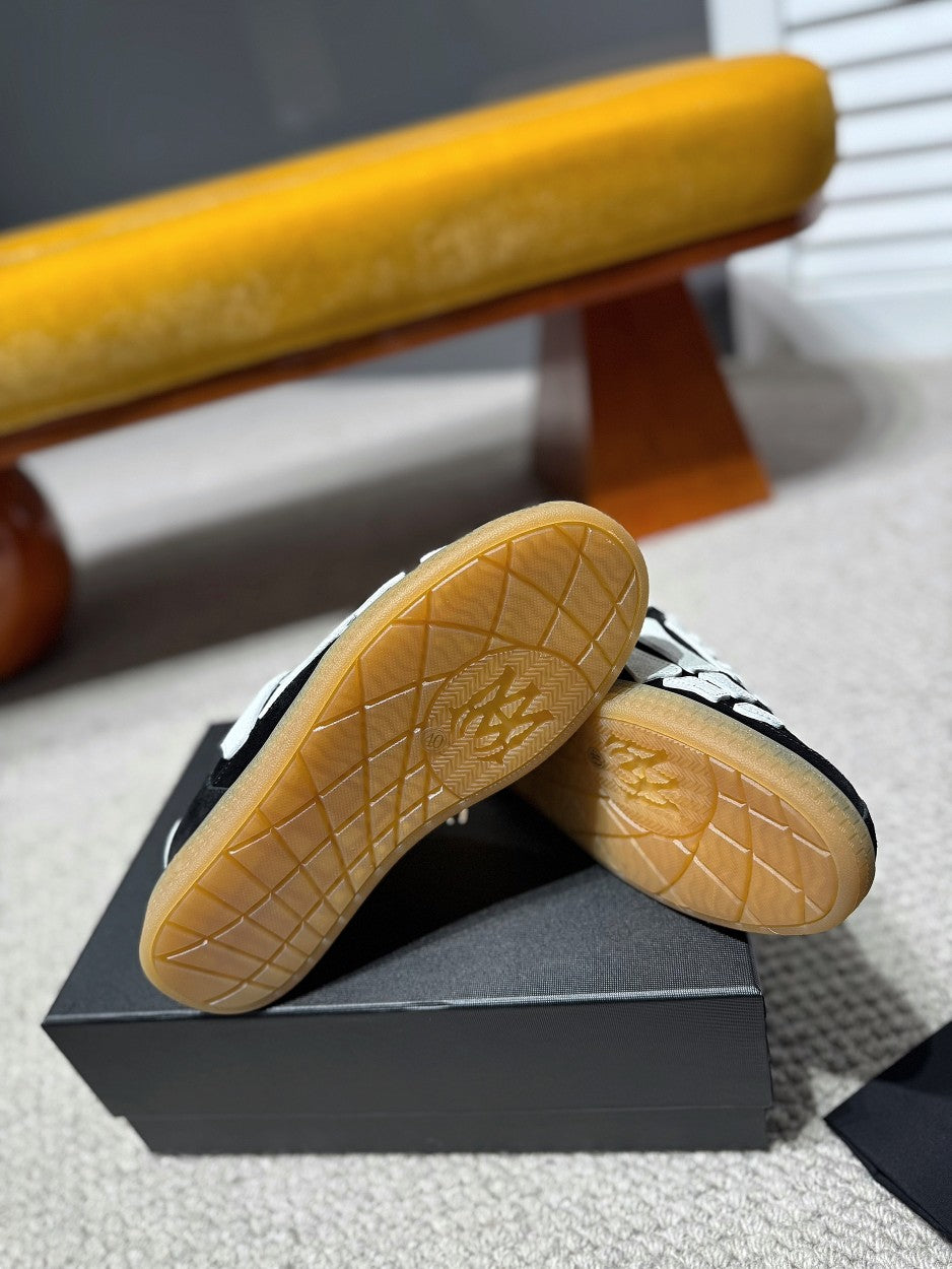Gum rubber outsole of black-and-white low-top sneaker with traction tread
