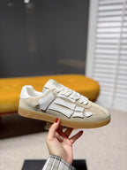 Amiri low-top sneakers in cream with gray logo details, lace-up, gum sole